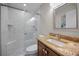 This bathroom features a glass shower with a built-in bench, granite countertop, and a framed mirror at 494 Village Dr, Tarpon Springs, FL 34689