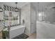This bathroom features a soaking tub, shower and geometric tile pattern at 494 Village Dr, Tarpon Springs, FL 34689