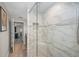 Elegant walk-in shower featuring glass door and marble style tiled walls at 494 Village Dr, Tarpon Springs, FL 34689