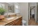 Bathroom vanity with granite countertops, wood cabinets and single sink at 494 Village Dr, Tarpon Springs, FL 34689
