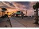 Coastal sunset view of a beach, pathway, shelter, and people enjoying the picturesque scenery at 494 Village Dr, Tarpon Springs, FL 34689