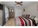 Cozy bedroom with wood look flooring, ceiling fan and double closet doors at 494 Village Dr, Tarpon Springs, FL 34689