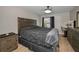 Bedroom with neutral walls, wood flooring, ceiling fan and window with blinds and curtains at 494 Village Dr, Tarpon Springs, FL 34689