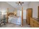 This bedroom features a four poster bed, wood floors and vaulted ceilings at 494 Village Dr, Tarpon Springs, FL 34689