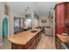 Open concept gourmet kitchen with island and breakfast bar seating overlooking living room at 494 Village Dr, Tarpon Springs, FL 34689