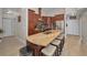 Spacious kitchen with stainless steel appliances, wood cabinets, large island with stone countertops and barstool seating at 494 Village Dr, Tarpon Springs, FL 34689