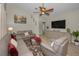 Comfortable living room featuring vaulted ceiling, ceiling fan, leather sofas and love seat and wood look flooring at 494 Village Dr, Tarpon Springs, FL 34689