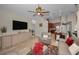 Open floor plan with neutral walls and wood look flooring, leather seating, view to kitchen and informal dining area at 494 Village Dr, Tarpon Springs, FL 34689