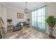 Cozy living room with wood-style floors, ample sunlight, and stylish decor at 494 Village Dr, Tarpon Springs, FL 34689