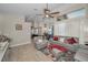 Open floor plan with neutral walls and wood flooring, leather seating, view to kitchen and informal dining area at 494 Village Dr, Tarpon Springs, FL 34689