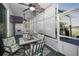 Enclosed patio with dining table, comfortable chairs, ceiling fans, and outdoor view at 494 Village Dr, Tarpon Springs, FL 34689