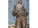 Close-up of a bronze sculpture of a diver in historic diving gear, set against a blue sky at 494 Village Dr, Tarpon Springs, FL 34689