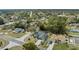 Aerial view of home featuring a screened pool, landscaping, and a spacious driveway at 5235 Elwood Rd, Spring Hill, FL 34608