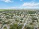 Aerial view displays a quiet residential neighborhood with tree-lined streets and scattered clouds above at 5235 Elwood Rd, Spring Hill, FL 34608