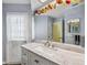 Nicely decorated bathroom featuring a marble vanity top, mirror, and bright natural lighting at 5235 Elwood Rd, Spring Hill, FL 34608