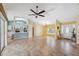 Bright living room and kitchen combo with tile floors, and a large window letting in natural light at 5235 Elwood Rd, Spring Hill, FL 34608