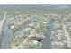 Aerial view of home on canal with a boat dock, set within a picturesque waterfront community at 5319 Ray Dr, Weeki Wachee, FL 34607