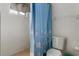 Clean bathroom with a tiled shower and a blue patterned shower curtain at 5319 Ray Dr, Weeki Wachee, FL 34607