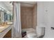 Bathroom featuring a shower-tub combination with tile surround, vanity with double sinks, and signs of wear and tear at 5319 Ray Dr, Weeki Wachee, FL 34607