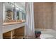 A dated bathroom features a shower/tub combo, double sink vanity, and is in need of renovations or updates at 5319 Ray Dr, Weeki Wachee, FL 34607