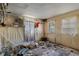 A bedroom filled with debris shows damage and disrepair, indicative of needed restoration and cleanup at 5319 Ray Dr, Weeki Wachee, FL 34607