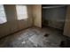 An aged bedroom featuring two windows and closet space at 5319 Ray Dr, Weeki Wachee, FL 34607