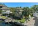 Waterfront home with dock and canal access, mature landscaping, and a brick-paved parking area at 5319 Ray Dr, Weeki Wachee, FL 34607