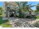 Exterior view of the home with a stairway leading to the second story and an outside utility area at 5319 Ray Dr, Weeki Wachee, FL 34607