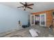 Open-concept living room with a view into another room, featuring a ceiling fan and unfinished flooring at 5319 Ray Dr, Weeki Wachee, FL 34607