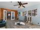 A living room showing a mix of wood paneling and painted walls under renovation, with unfinished floors and scattered objects at 5319 Ray Dr, Weeki Wachee, FL 34607