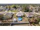 Overhead view of a home with a pool and screened patio, nestled in a mature neighborhood at 6036 Dorset Rd, Spring Hill, FL 34608