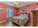 Charming bedroom with wood floors, a decorative bedspread, and a window at 6036 Dorset Rd, Spring Hill, FL 34608