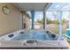 Backyard featuring a hot tub under a screened patio, with backyard views at 6036 Dorset Rd, Spring Hill, FL 34608