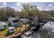 Aerial view of waterfront homes with private docks lining a canal, surrounded by mature trees and lush lawns at 6183 Waverly Rd, Weeki Wachee, FL 34607