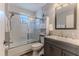 Cozy bathroom featuring a shower-tub combination and grey vanity with storage at 6183 Waverly Rd, Weeki Wachee, FL 34607