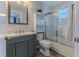 Bathroom featuring a shower-tub combination, grey vanity, and decorative shelving at 6183 Waverly Rd, Weeki Wachee, FL 34607