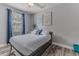 Bright bedroom with gray walls and flooring, and a double bed at 6183 Waverly Rd, Weeki Wachee, FL 34607