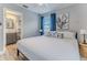 Bright bedroom with a ceiling fan, blue curtains, and ensuite bathroom entrance at 6183 Waverly Rd, Weeki Wachee, FL 34607