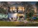Inviting two-story home with a garage, screened porch, patio, and outdoor seating around a fire pit at 6183 Waverly Rd, Weeki Wachee, FL 34607