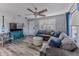 Comfortable living room boasts a large sectional sofa, stylish decor, and a ceiling fan for added comfort at 6183 Waverly Rd, Weeki Wachee, FL 34607