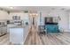 A contemporary living area with an open floor plan, seamlessly connecting the kitchen and living room at 6183 Waverly Rd, Weeki Wachee, FL 34607