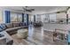 Open-concept living space with dining area, modern kitchen, and access to a balcony through sliding glass doors at 6183 Waverly Rd, Weeki Wachee, FL 34607