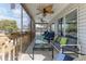 Relaxing screened porch with comfortable seating, ceiling fans, and views of waterfront scenery at 6183 Waverly Rd, Weeki Wachee, FL 34607