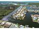 Breathtaking aerial view of waterfront homes with private docks and lush landscaping in a serene coastal community at 6627 Leeside Isle, Hudson, FL 34667