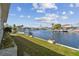 A grassy backyard with a waterfront view and a dock and lift at 6627 Leeside Isle, Hudson, FL 34667