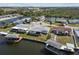 Waterfront homes boasting private boat docks on a tranquil canal, with lush green lawns at 6627 Leeside Isle, Hudson, FL 34667