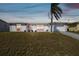 Single-story home with an attached garage, bright exterior, and tidy lawn at 6627 Leeside Isle, Hudson, FL 34667