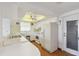 Clean kitchen with white cabinets and appliances and views into the backyard and the adjacent office space at 6627 Leeside Isle, Hudson, FL 34667