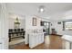 Bright kitchen showing white cabinets and appliances, plus view into formal dining area and water view at 6627 Leeside Isle, Hudson, FL 34667