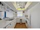A clean, bright kitchen with white appliances and cabinets and views into the backyard and the adjacent office at 6627 Leeside Isle, Hudson, FL 34667